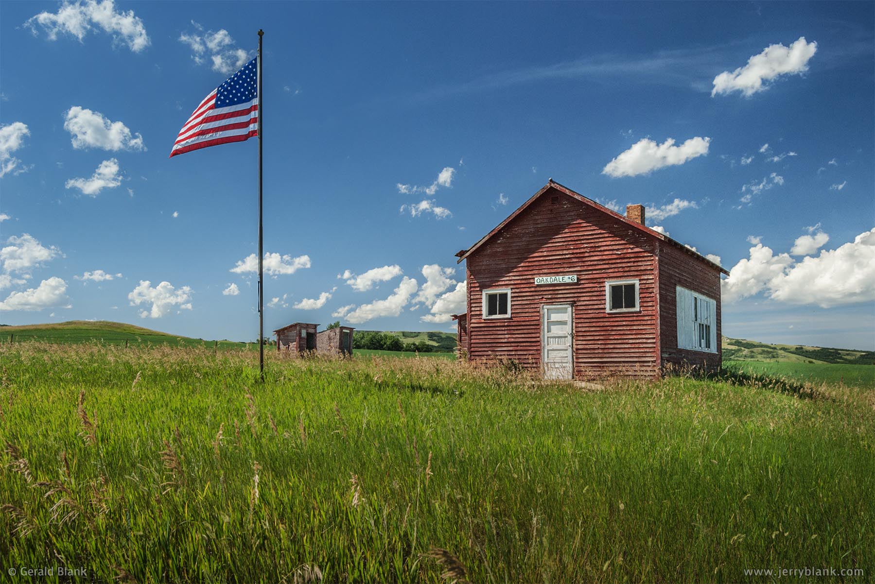 #01028 - On Independence Day, the U.S. flag is raised once again at the historic Oakdale School building in Dunn County, North Dakota - photo by Jerry Blank