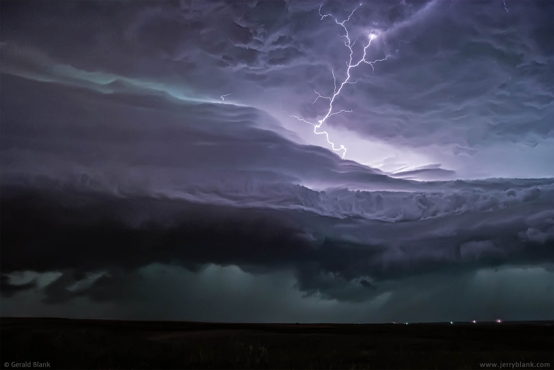 #01907 - Lightning illuminates approaching storm clouds, north of Williston, North Dakota - photo by Jerry Blank