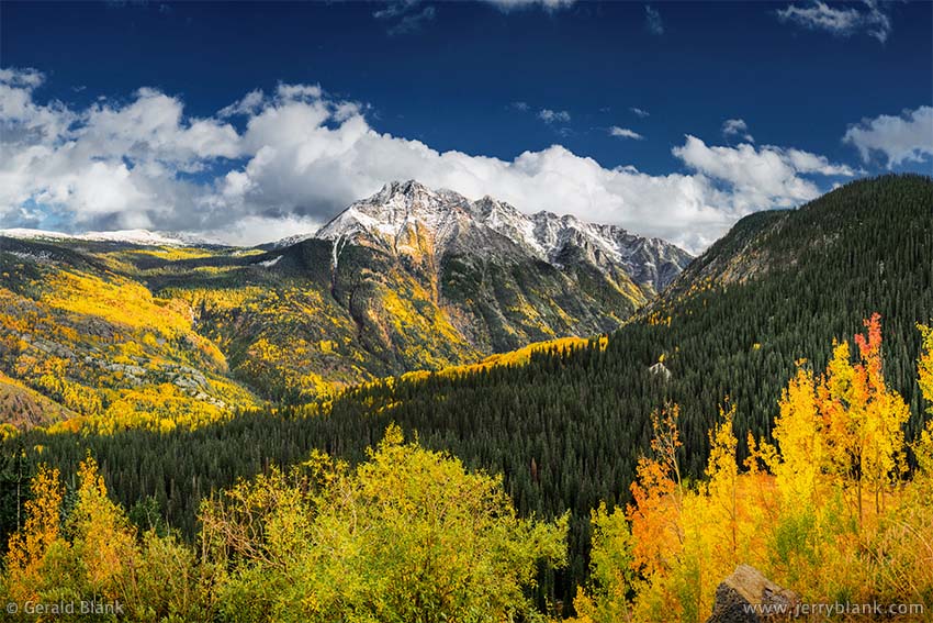 #52266 - The Twilight Peaks in the San Juan Mountains are surrounded by vivid autumn aspen color in this view from Coal Bank Pass on US Hwy. 550 in Colorado - photo by Jerry Blank