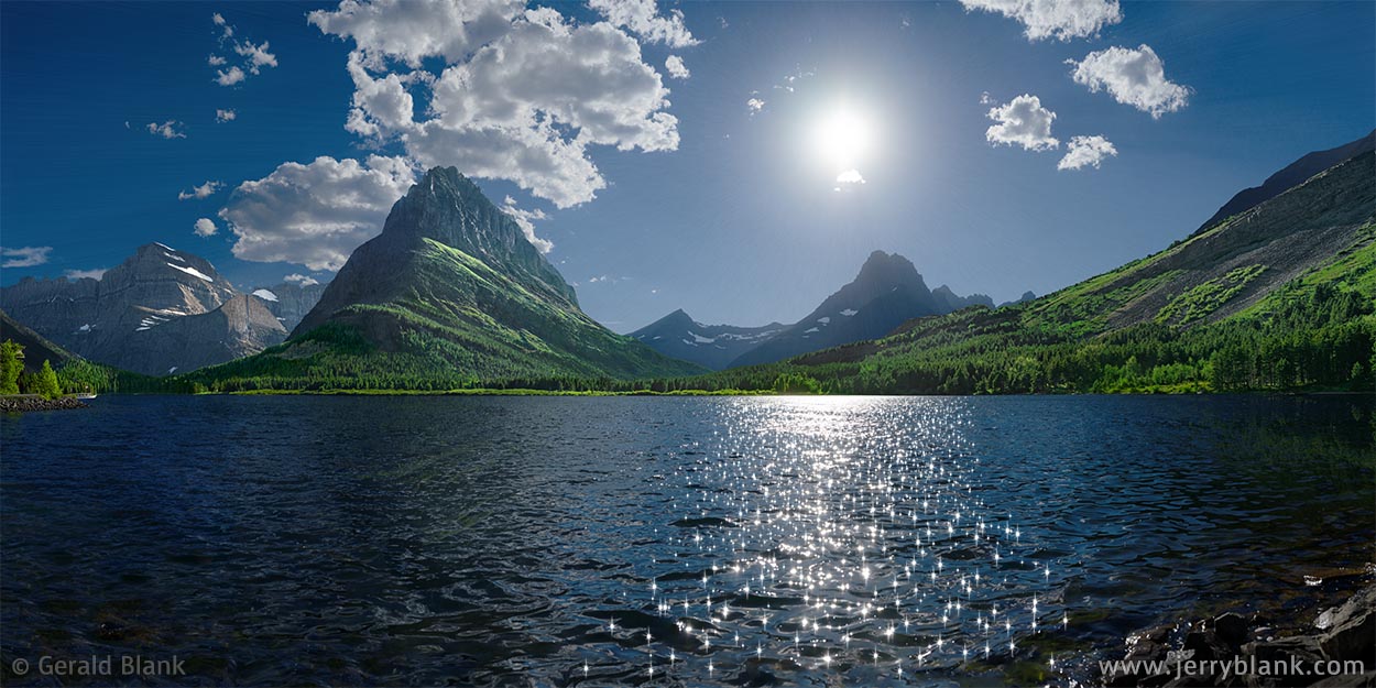 #67962 - The evening sun sparkles on Swiftcurrent Lake in Glacier National Park, Montana. Grinnell Point is seen at center-left, and Mount Wilbur is visible below the sun. Photo by Jerry Blank.